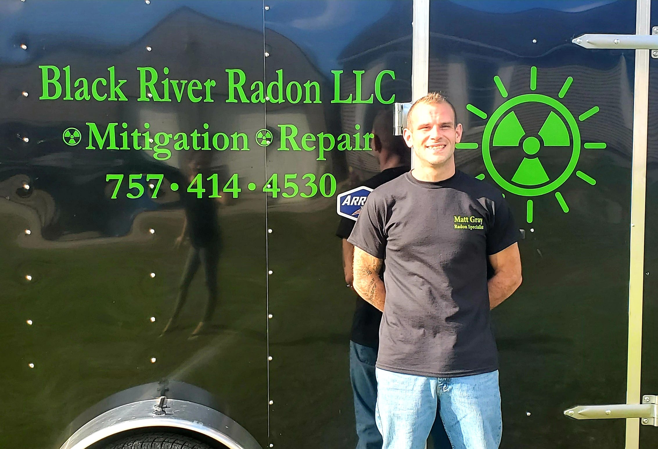 Matthew Gray in front of radon company trailer