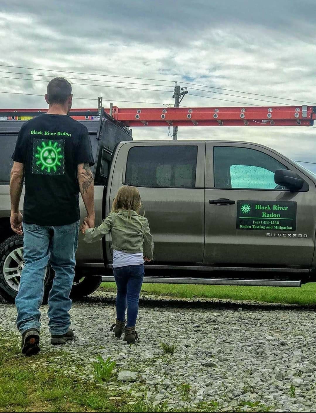 Matthew Gray walking with daughter to radon company truck